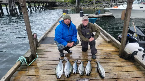 Two men showing their catch