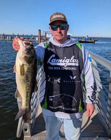 Kyle Clark holding a largemouth bass