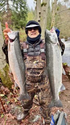 Paul Proios holding two Steelhead