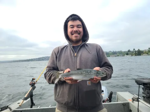 Man holding kokanee.