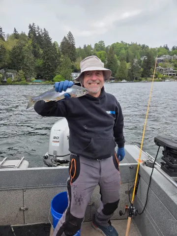 Man holding a kokanee.
