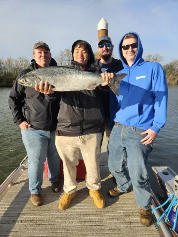 Group of people with one holding a large chinook.