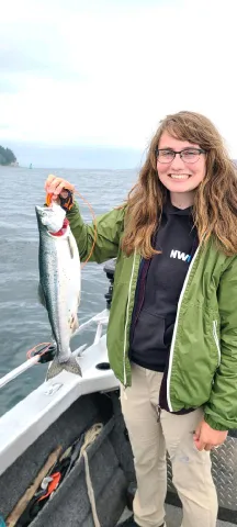 Hannah Pennebaker holding a salmon.