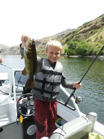 Boy holding smallmouth bass.