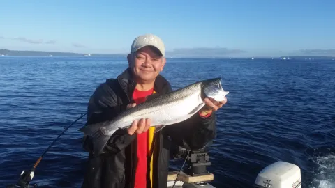 Person holding coho salmon